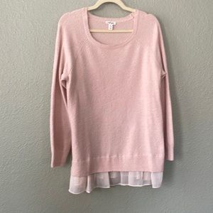Pale pink V-neck sweater top with ruffle hem